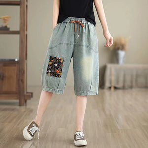 Quần sooc denim lưng thun dây rút thêu ô cửa hoa lá - NU10494