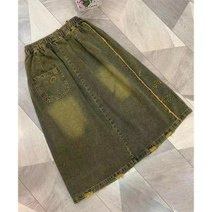 Chân váy denim lưng thun dây rút thêu hoa một bên - NU9192