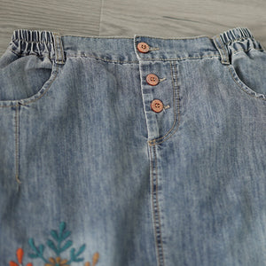 Chân váy denim lưng thun thêu hoa lá vạt xẻ trước - V106